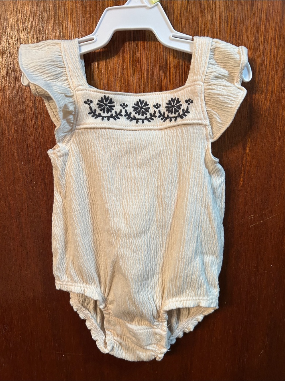 Cream Ruffle-Sleeve Baby One-Piece with Dark Grey Floral Embroidery